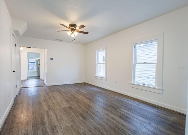 1007 11th St, Saint Cloud, FL 34769 - spare room featuring dark wood-type flooring, baseboards, visible vents, and ceiling fan