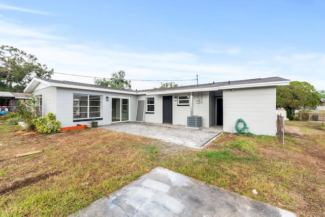 4445 Stuart Ave, Titusville, FL 32780 - back of house with a patio, a lawn, and central air condition unit