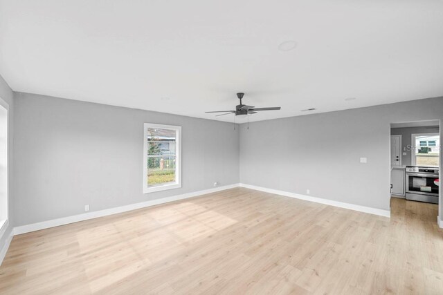 4445 Stuart Ave, Titusville, FL 32780 - unfurnished room with a ceiling fan, light wood finished floors, and baseboards