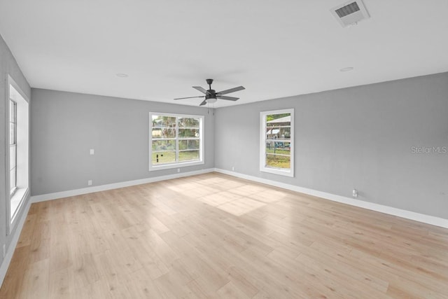 4445 Stuart Ave, Titusville, FL 32780 - spare room featuring light wood finished floors, ceiling fan, and baseboards