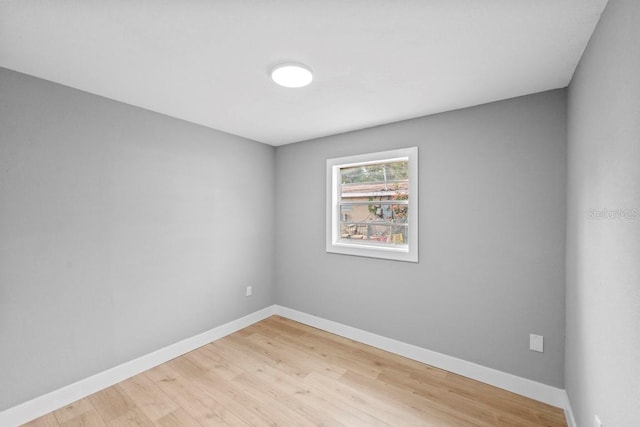 4445 Stuart Ave, Titusville, FL 32780 - spare room featuring baseboards and light wood-style flooring