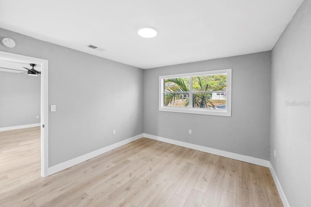 4445 Stuart Ave, Titusville, FL 32780 - unfurnished room featuring light wood-style floors, a smoke detector, baseboards, and ceiling fan