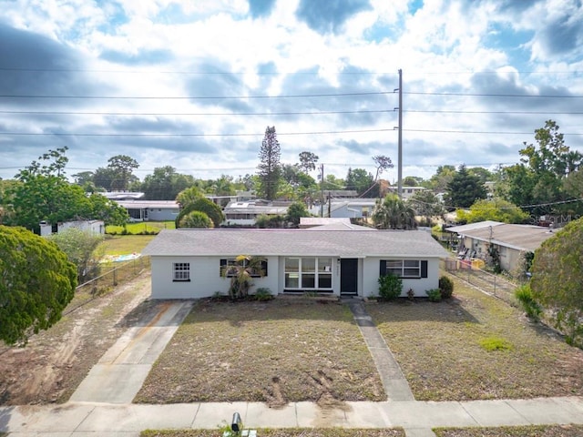 4445 Stuart Ave, Titusville, FL 32780 - view of front of home featuring concrete driveway, fence, and stucco siding