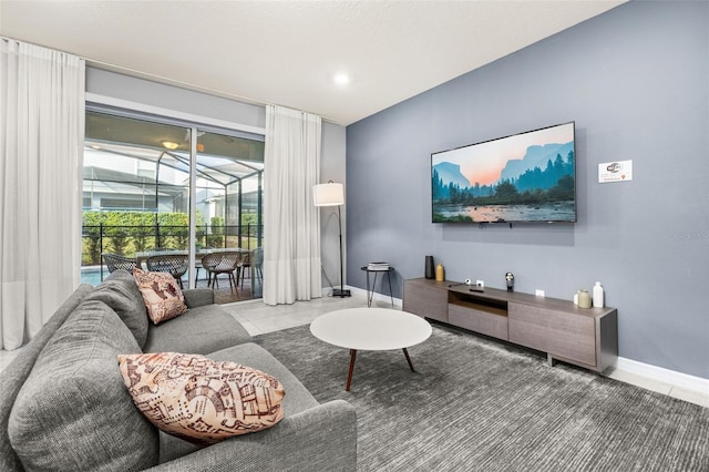 tiled living area with a sunroom and baseboards