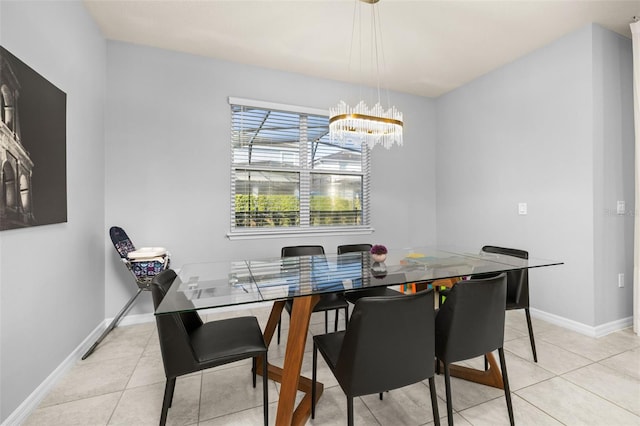 dining space featuring a chandelier, light tile patterned floors, and baseboards