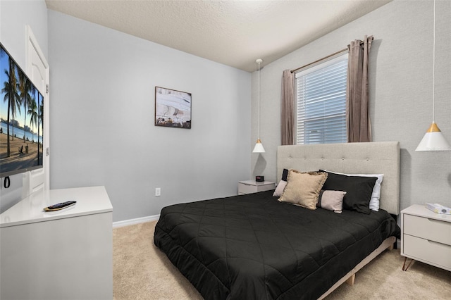 bedroom featuring light carpet and baseboards
