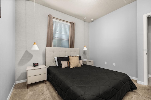 bedroom featuring light colored carpet and baseboards
