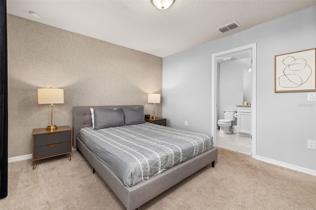 bedroom featuring carpet flooring, baseboards, and connected bathroom