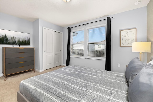 bedroom with carpet, baseboards, and a closet