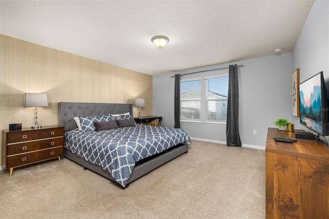 bedroom with baseboards, carpet flooring, and a textured ceiling