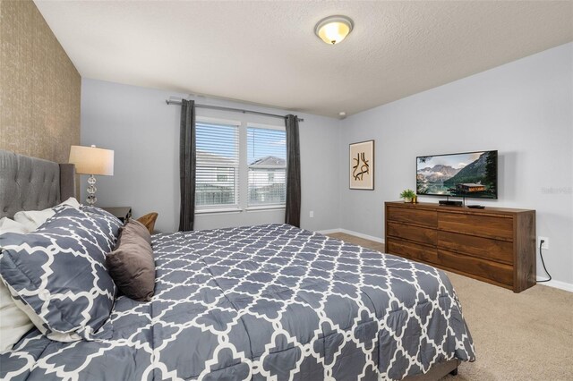 bedroom featuring carpet, a textured ceiling, and baseboards
