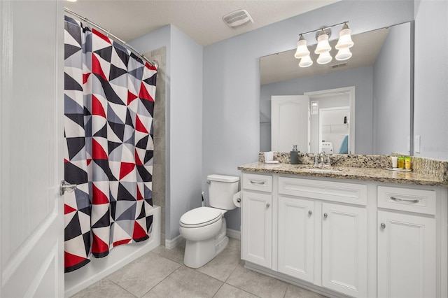 bathroom featuring toilet, tile patterned floors, vanity, and shower / tub combo with curtain