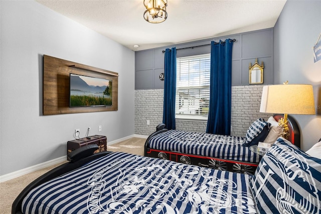 carpeted bedroom with baseboards and a textured ceiling