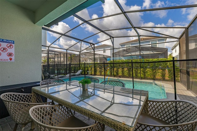 view of patio / terrace featuring an outdoor pool and glass enclosure