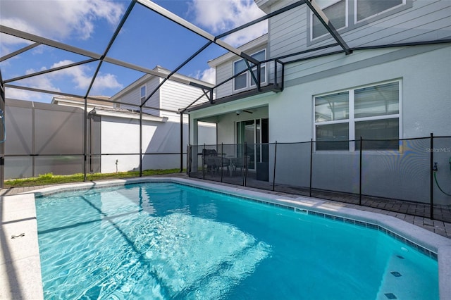 view of swimming pool with a patio area and a lanai