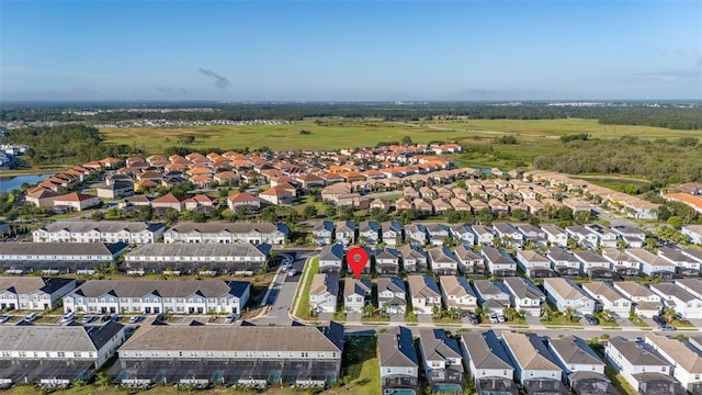 aerial view of property and surrounding area with nearby suburban area