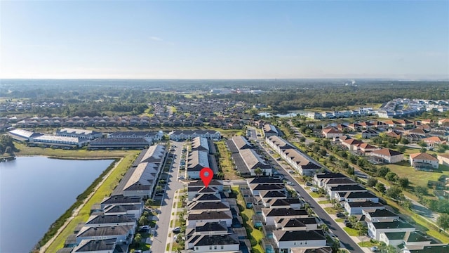 aerial view of property and surrounding area featuring nearby suburban area and a nearby body of water