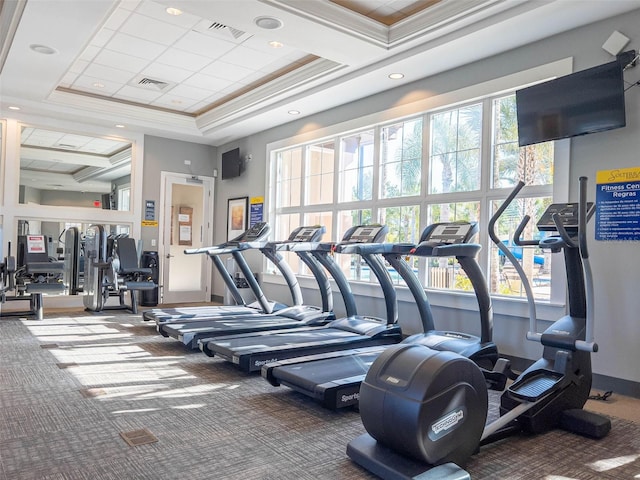 gym with carpet flooring, a raised ceiling, crown molding, a towering ceiling, and recessed lighting