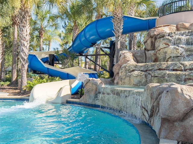 outdoor pool with a water slide