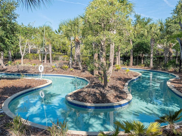 view of pool featuring fence