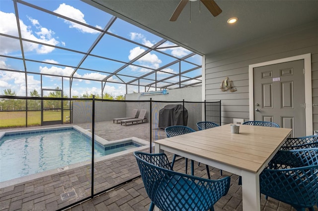 outdoor pool with a patio, a ceiling fan, a hot tub, a lanai, and outdoor dining area