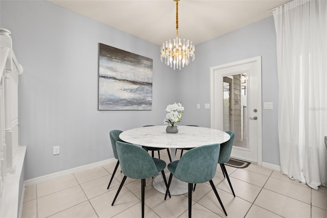 dining area with a chandelier, light tile patterned floors, and baseboards