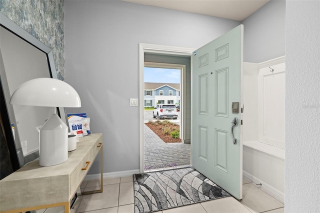 entryway featuring baseboards and light tile patterned floors