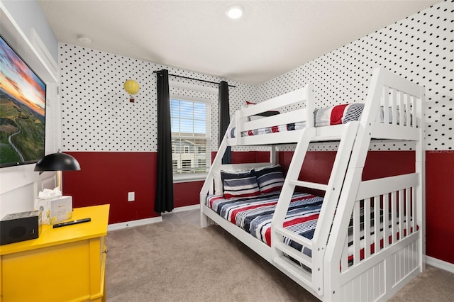 bedroom featuring baseboards, carpet flooring, and wallpapered walls