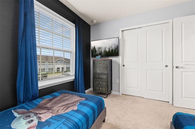 bedroom featuring carpet floors, a closet, and baseboards