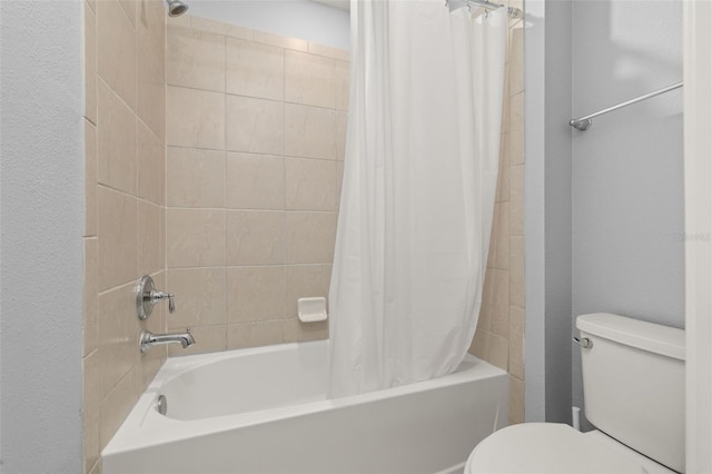 full bath featuring toilet, shower / bath combination with curtain, and a textured wall