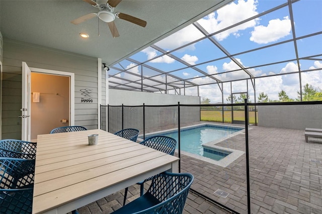 outdoor pool with a patio area, ceiling fan, outdoor dining area, and a lanai
