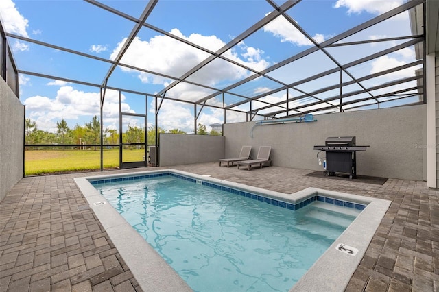 swimming pool with area for grilling, a patio area, and glass enclosure