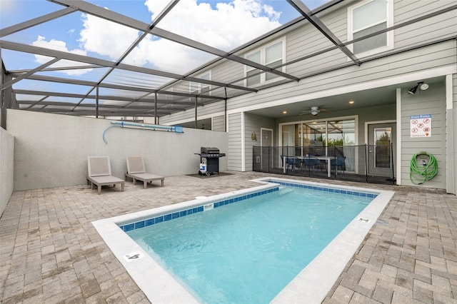 view of swimming pool with a patio, a swimming pool, a lanai, and a grill