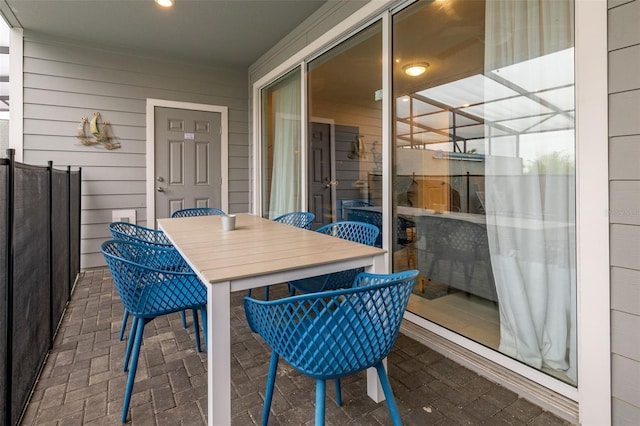 sunroom featuring outdoor dining space