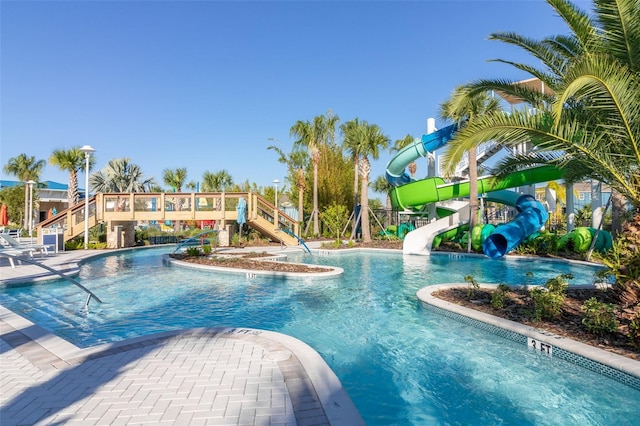 community pool with a water slide and stairs