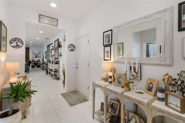 corridor featuring tile patterned flooring, recessed lighting, and baseboards