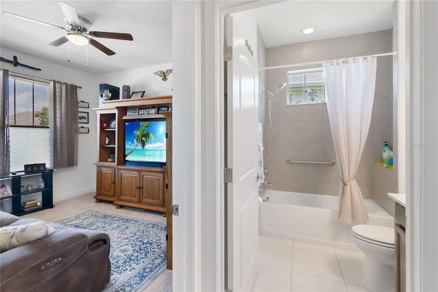 living area featuring a ceiling fan and baseboards