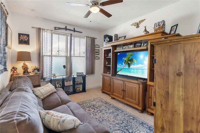 living area with ceiling fan and light colored carpet