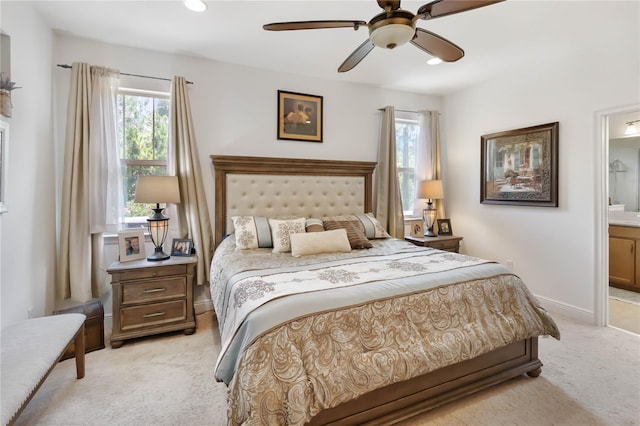 bedroom with light carpet, multiple windows, connected bathroom, recessed lighting, and a ceiling fan