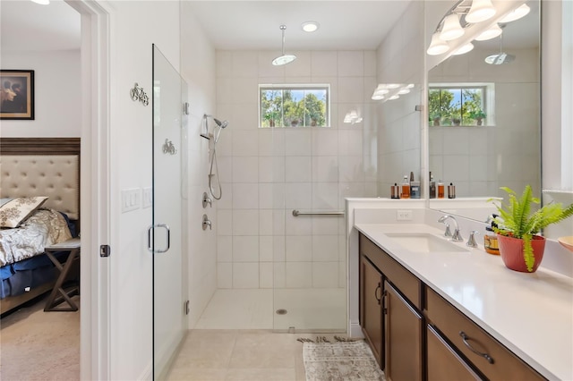 ensuite bathroom with a shower stall, vanity, and tile patterned floors