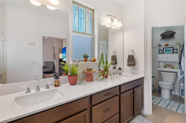 full bath featuring double vanity and toilet