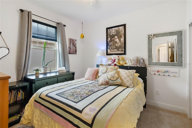carpeted bedroom featuring baseboards