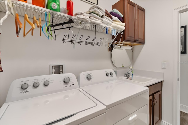 washroom with separate washer and dryer and cabinet space