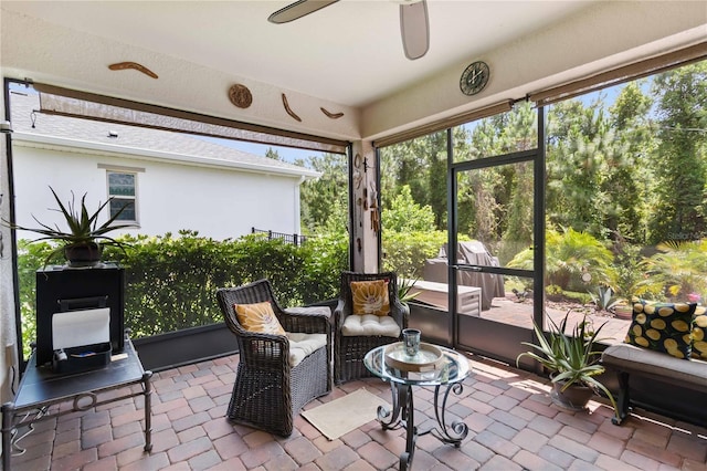 sunroom with a ceiling fan
