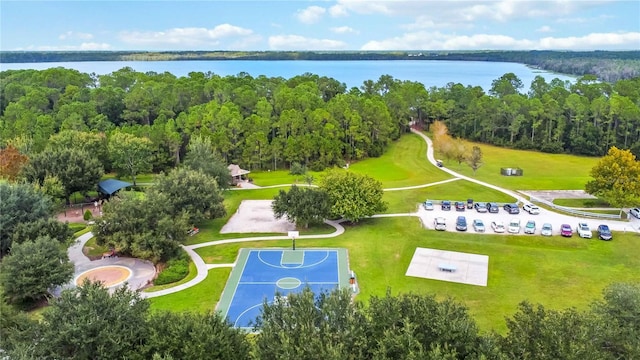 drone / aerial view of a nearby body of water and a forest