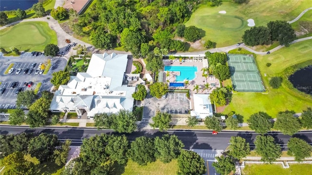 aerial view of property's location with a golf club and a pool area