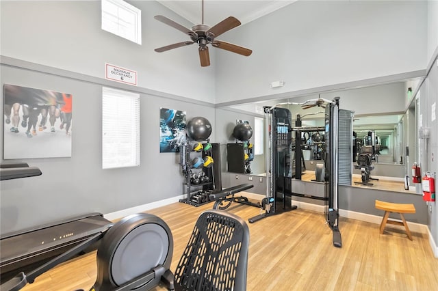 3378 Sagebrush St, Harmony, FL 34773 - workout area with ceiling fan, wood finished floors, a high ceiling, baseboards, and crown molding