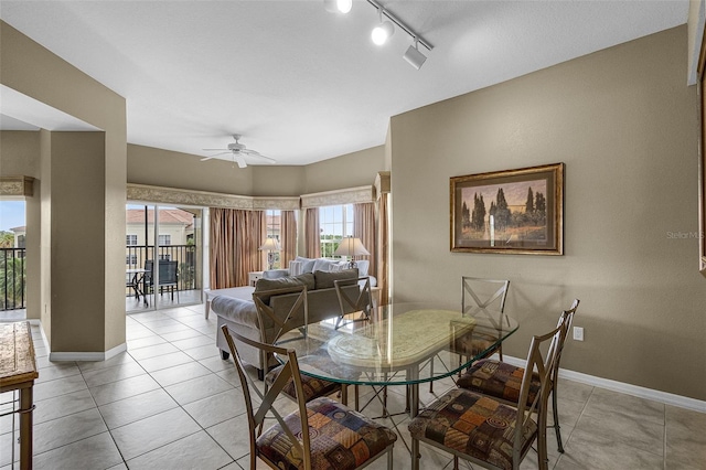 dining area with ceiling fan, track lighting, light tile patterned floors, and baseboards