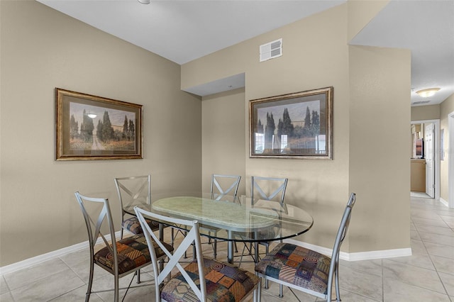 dining space with light tile patterned flooring, baseboards, and visible vents