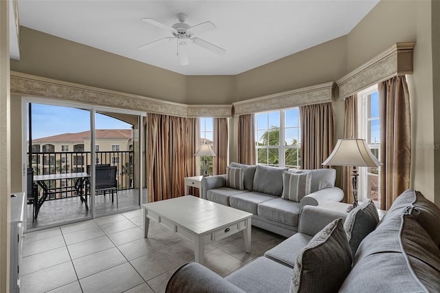 living area with a ceiling fan and light tile patterned floors